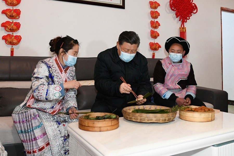 2021年2月3日下午，習近平在貴州畢節(jié)市黔西縣新仁苗族鄉(xiāng)化屋村苗族村民趙玉學家，同一家人邊聊家常邊制作當?shù)貍鹘y(tǒng)節(jié)日食品黃粑。新華社記者 李學仁 攝